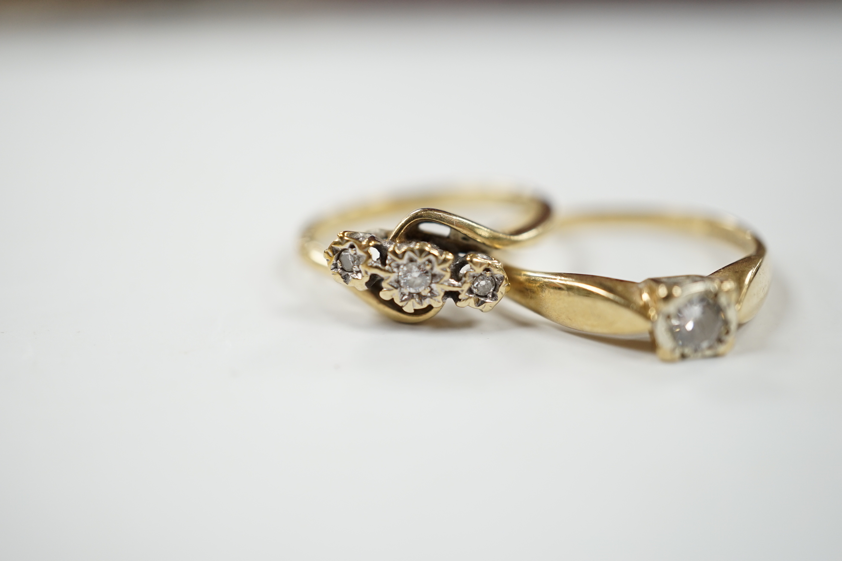 Two 9ct gold and diamond set rings including three stone and solitaire